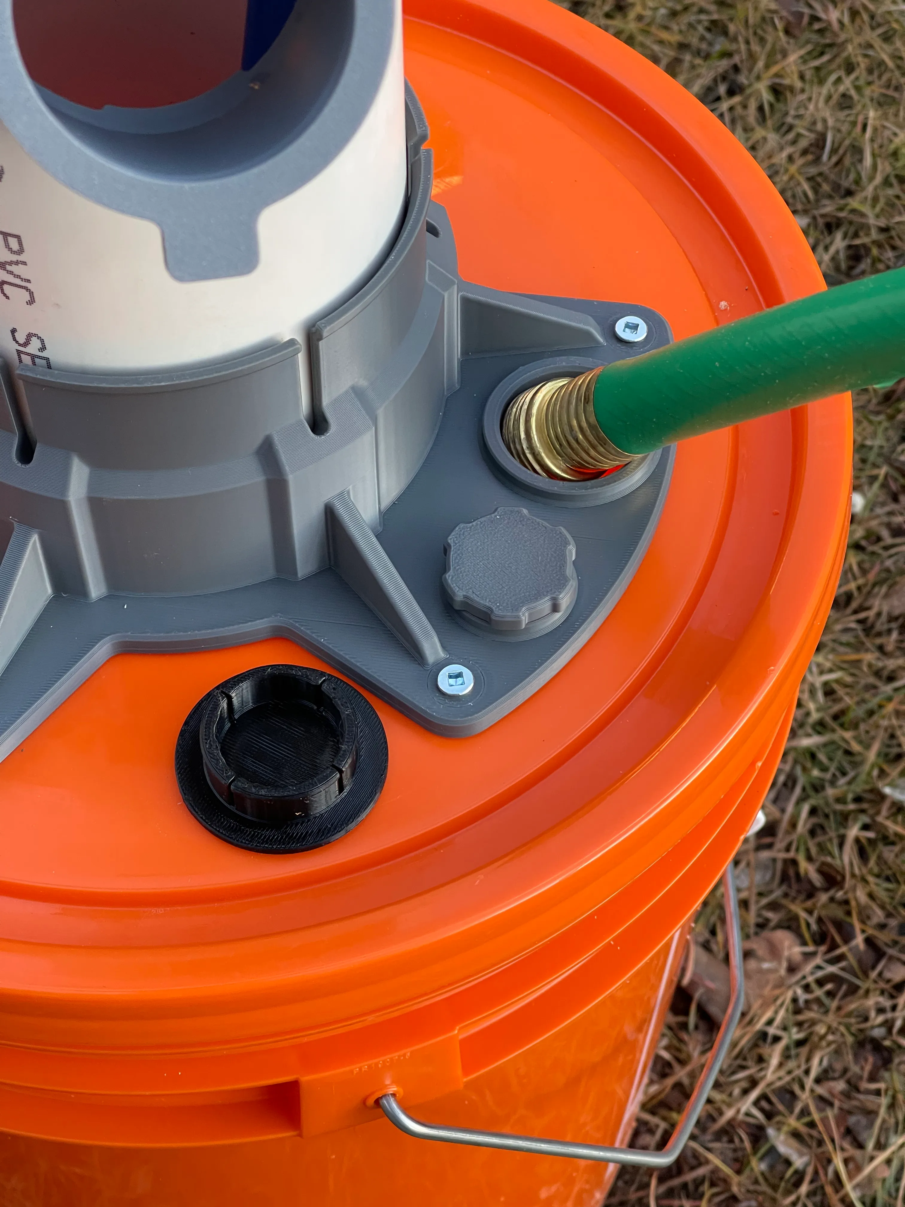 HydroSnap Tower being filled with garden hose inserted into HydroSnap base fill port, with TPU rubber fill plug removed